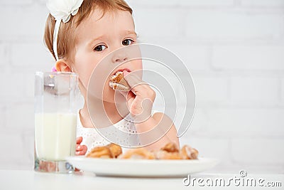 Happy child girl eats cookies and milk - happy-child-girl-eats-cookies-milk-little-58710104