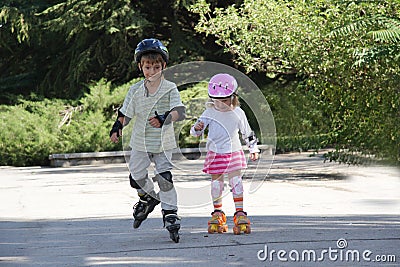 Happy children on roller blades outdoors