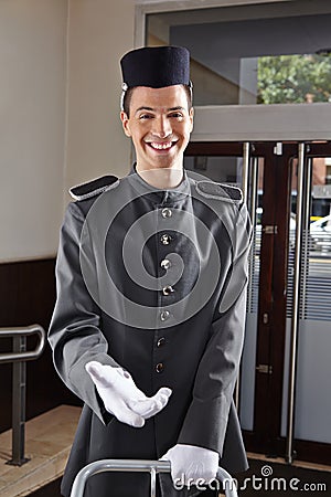 Happy concierge in hotel uniform