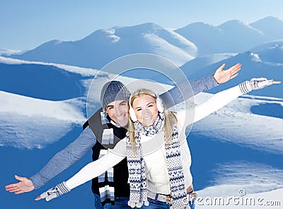 Happy couple playing outdoor at winter mountains