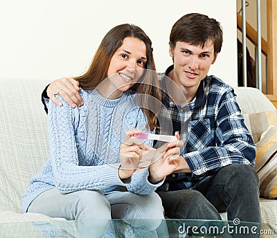 Happy couple with pregnancy test