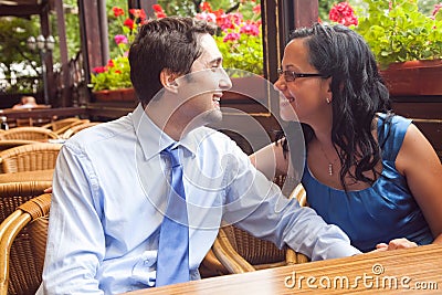 Happy couple at restaurant on honeymoon