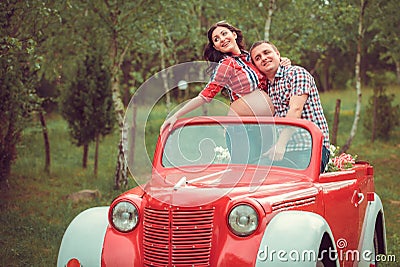 Happy couple in retro red car