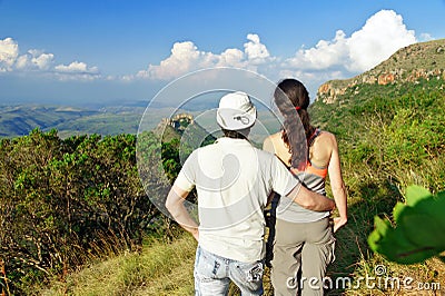 Happy couple trekking in mountains, hiking tourists