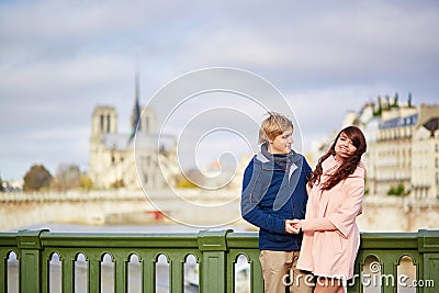 Happy dating couple walking in Paris