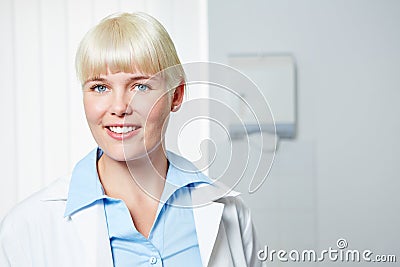 Happy dentist in her dental practice