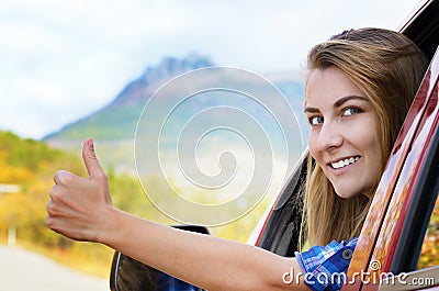 Happy driver woman shows thumb up