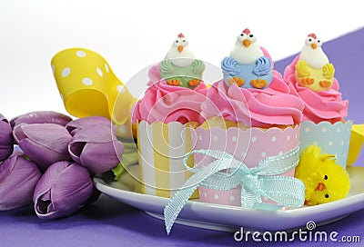 Happy Easter pink, yellow and blue cupcakes with copy space