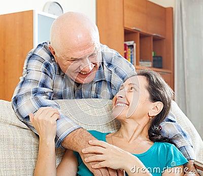 Happy elderly man flirting with mature woman