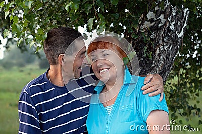 Happy elderly seniors couple in park