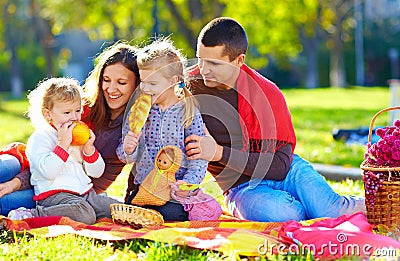 Happy family on autumn picnic in park