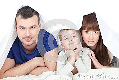 Happy family with child in bed