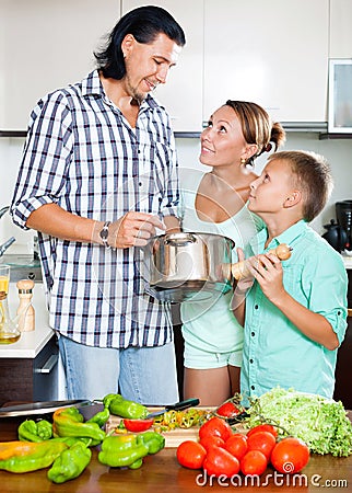 Happy family cooking food together