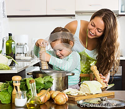 Happy family cooking soup