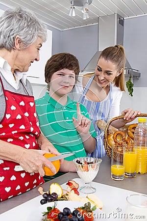 Happy family cooking together - with the grandmother