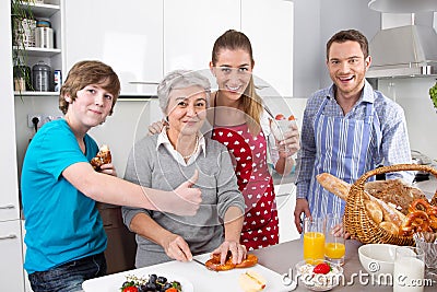 Happy family cooking together - with the grandmother.
