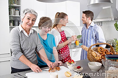 Happy family cooking together - with the grandmother