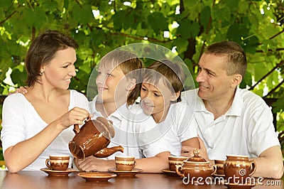 Happy family drinking tea