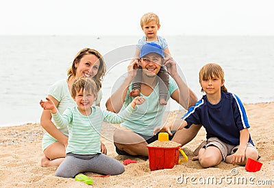 Happy family of five at sea shore