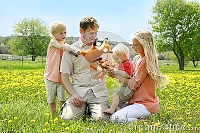 Happy Family of Four People Playing with Toys Outside in Flower