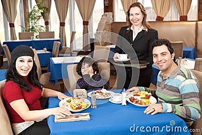 Happy family having breakfast at a restaurant
