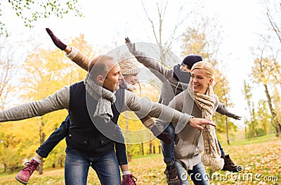 Happy family having fun in autumn park