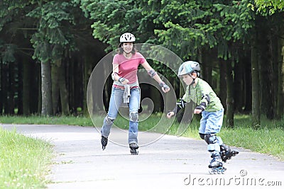 Happy family learning to ride on rollerblades