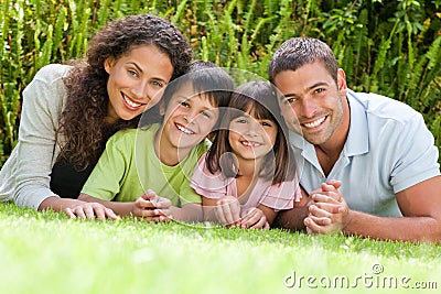 Happy family lying down in the garden