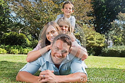 Happy family members lying on each other