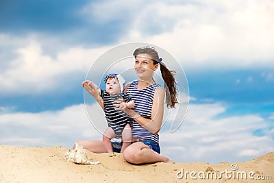 Happy family, mom and little son in striped vests having fun in