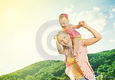 Happy family. mother and daughter baby girl playing on nature