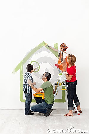 Happy family painting their home together