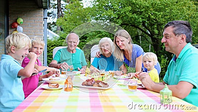 Happy family of seven having meal together