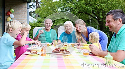 Happy family of seven having meal together