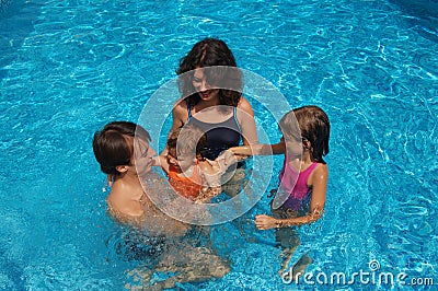 Happy family in swimming pool