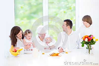Happy family with three children visiting grandmother