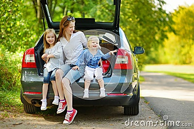 Happy family of three going to a car vacation