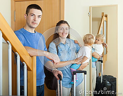 Happy family of three with luggage