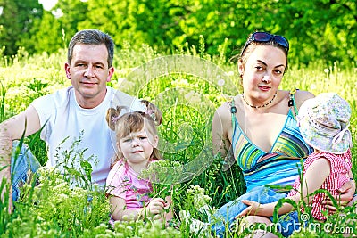Happy family with two daughters outdoors