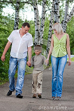 Happy family walking in the park
