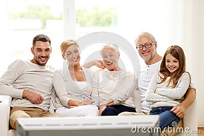 Happy family watching tv at home