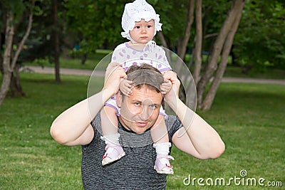 Happy father and child girl hugging. Dad and his baby outdoors