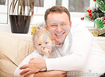 Happy father and child girl hugging and laughing