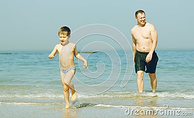 Happy father and his son on the sea