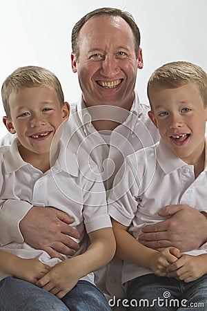 Happy Father holding his 6 years old twins