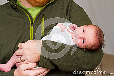 Happy Father Holding Newborn