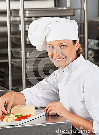 Happy Female Chef Garnishing Dish