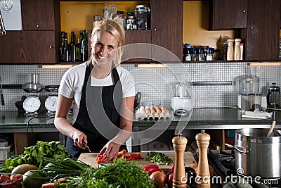 Happy female chef in the kitchen