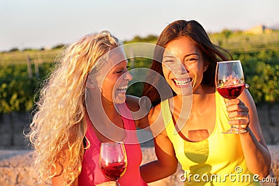 Happy friends drinking wine laughing