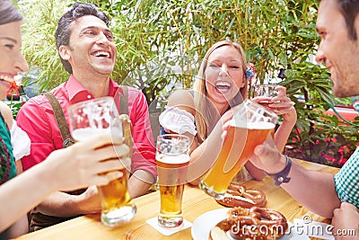 Happy friends laughing in beer